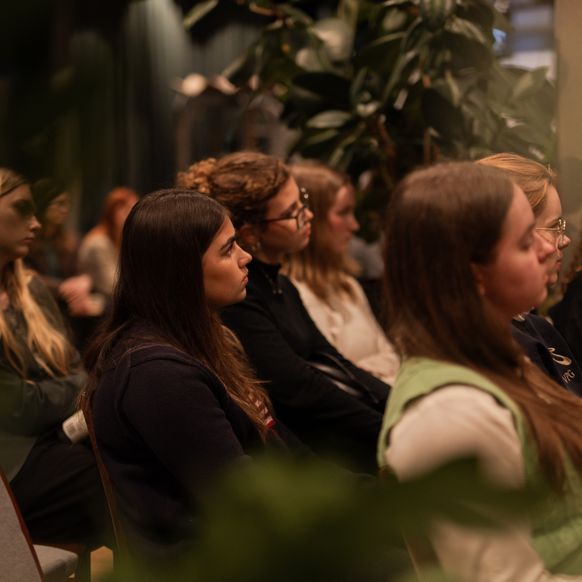 Highschool girl listening to a panel of female leaders at Vinted